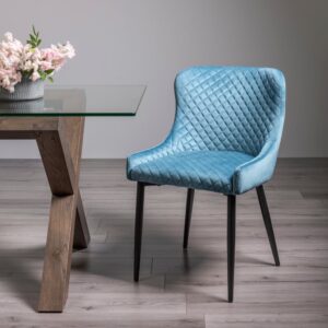 Cezanne armchair combines comfort and style with diamond-quilted upholstery, velvet or faux leather finishes, and sleek black metal legs for a luxe look.